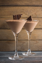 Chocolate mousse in martini glass on the wooden background