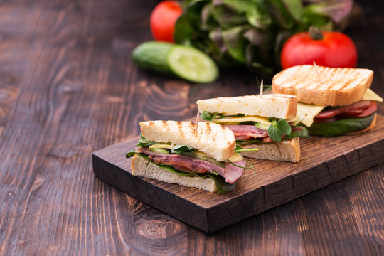 Sandwiches with bacon, cheese, greens and pea sprouts
