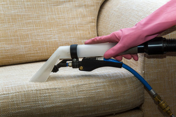 Sofa or armchair chemical cleaning with professionally extraction method. Dirty upholstered...