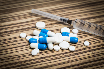 Still life drugs and syringe on table