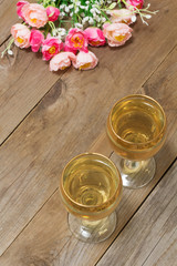 Two glasses of white wine and flowers