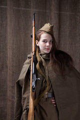 Fototapeta premium Woman in Russian military uniform with rifle. Female soldier during the second world war.