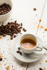 Coffee Cup, Beans, Cinnamon Sticks on White Wooden table