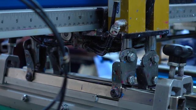 Industrial silk screen printing machine in action