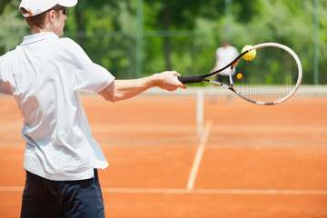Friends playing tennis, forehand shot