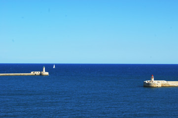 Two white lighthouse on the coast of Malta in the Mediterranean Sea