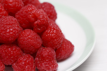 Fresh raspberries in white dish
