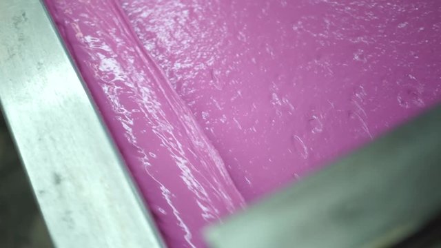 Industrial silk screen printing machine in action