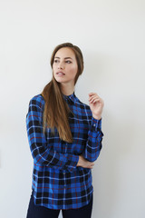 Gorgeous woman in blue checked shirt, looking away