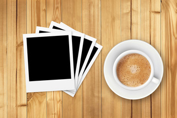 old photo card and coffee cup on wooden table background