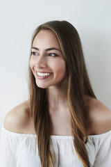 Fototapeta premium Stunning brown eyed girl looking away, smiling