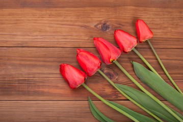 Fototapeta na wymiar Bouquet of red tulip on wooden background.