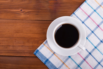 Cup of coffee on the kitchen table. View from above .