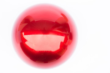 Shiny hard red ball on white background