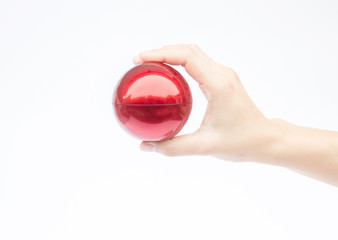 Hand on shiny red ball on white background