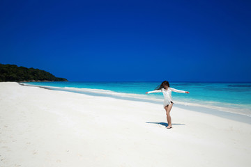 Enjoyment. Carefree happy woman open arms on tropical beach, exo