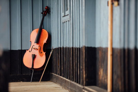 cello leaning on a porch
