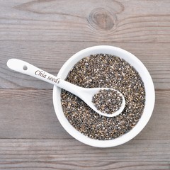 Chia seeds on wood background.   