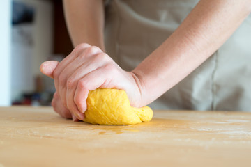 woman hands kneading dough for homemade fresh pasta