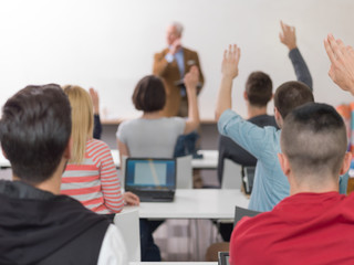 Naklejka na ściany i meble students group raise hands up on class