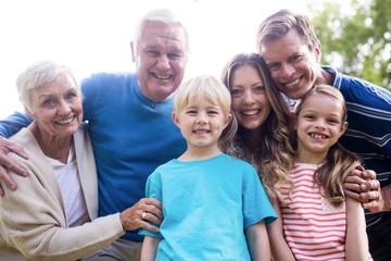 Multi-generation family standing in the park