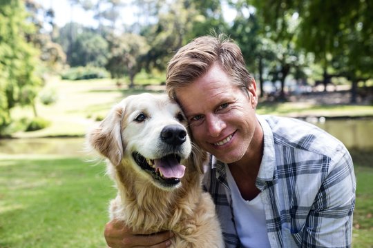 Smiling Man With His Pet Dog In The Park