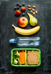 Keuken spatwand met foto School lunch box with sandwich, vegetables, water and fruits © pinkyone
