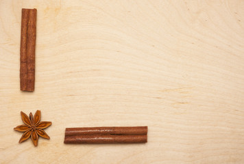 Cinnamon sticks and star anise on wooden background. Aromatic spices for healthy and flavored food.