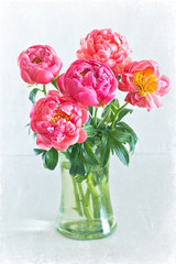 Close-up floral composition with a pink peony on a light background.