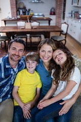 Portrait of happy family sitting on a sofa