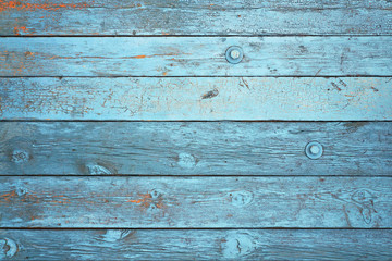 Background of blue boards with peeling paint.