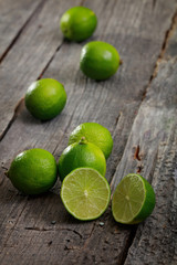 Limes scattered on wooden table