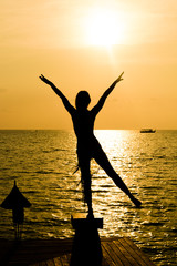 Young women on the beach and enjoy the sunset