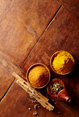 Curry and turmeric beside copy space on table