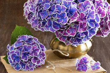 Beautiful bouquet of flowers.Still Life with Hortensia Flowers on a brown background .