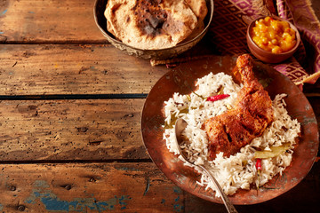 Rustic table set with indian cuisine of chicken