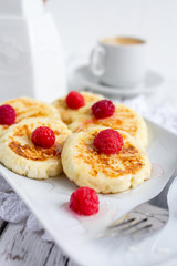 Homemade сottage cheese pancakes with raspberries and honey