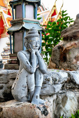 Detailed statue and architecture in Wat Pho, Buddhist temple, Bangkok, Thailand. Wat Pho known also as the Temple of the Reclining Buddha.