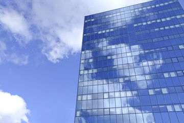 Fototapeta na wymiar Big blue office building with sky reflection
