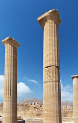 Columns in ancient Acropolis of Lindos against the blue sky, Rhodes, Greece
