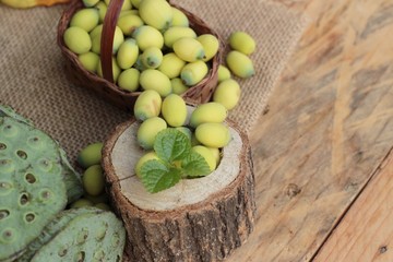 Lotus seeds in nature on wood background.