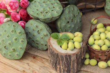 Lotus seeds in nature on wood background.