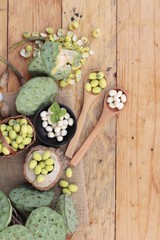 Lotus seeds in nature on wood background.
