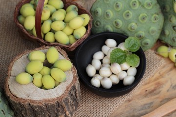 Lotus seeds in nature on wood background.
