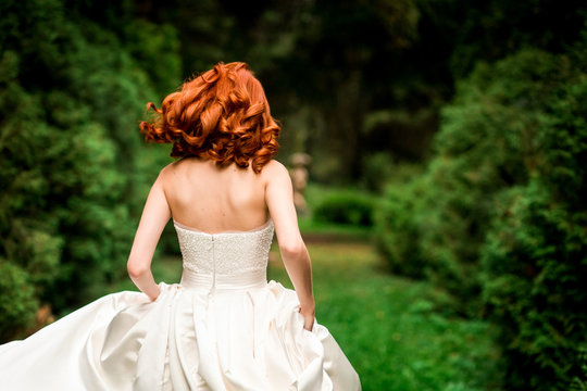 Red-haired Bride Is Running In The Park