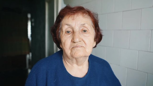 portrait of an old woman in a blue dress