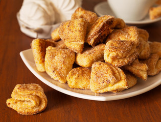 Sweet homemade cookies from the cottage cheese dough on a wooden table