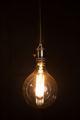Fototapeta na wymiar vintage light bulb over dark