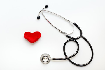 stethoscope on white background with plush heart