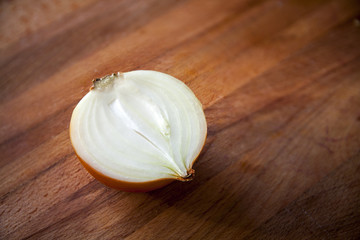 Close-up of half onion on wood